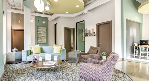 a living room with a blue couch and two chairs